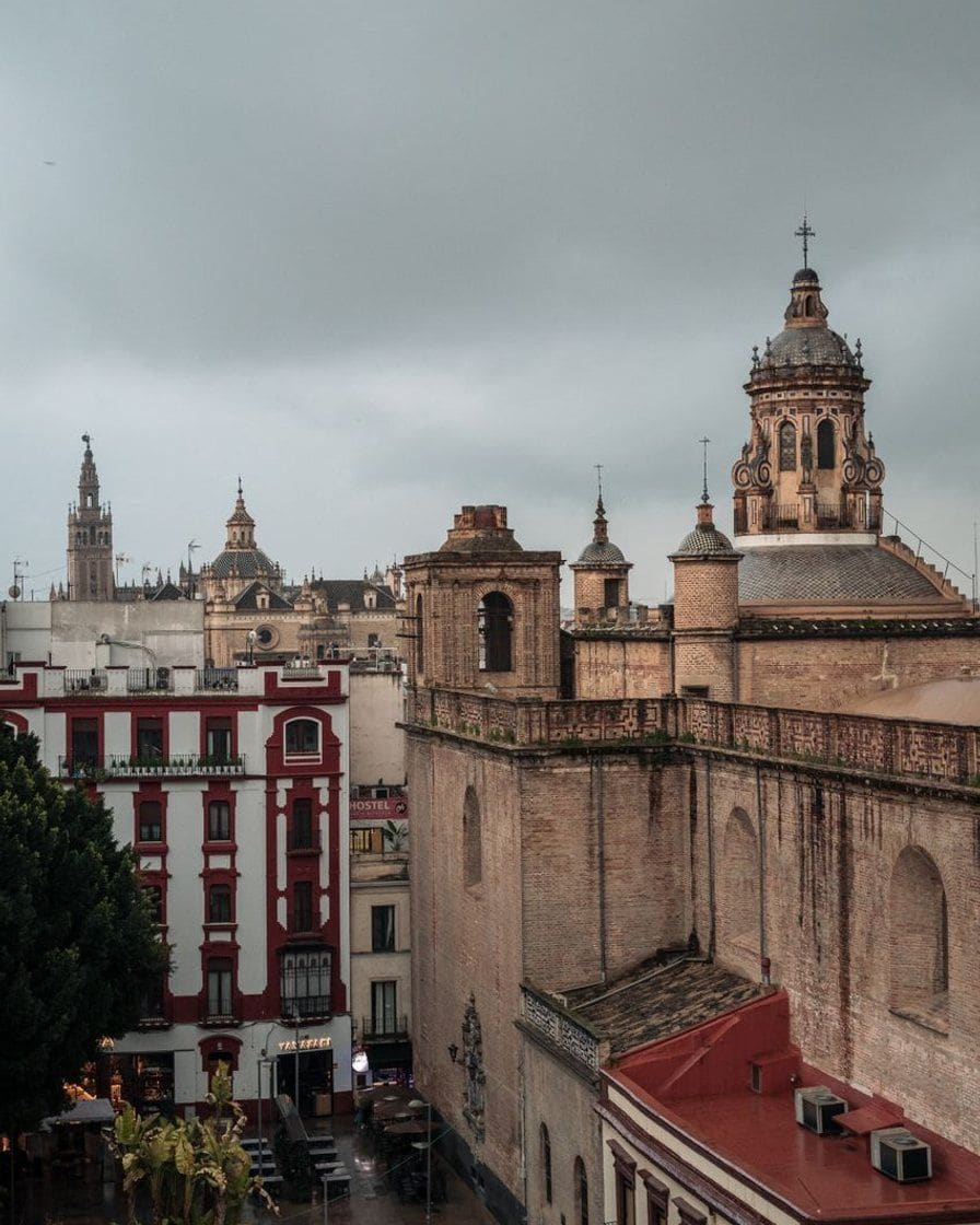 Partly cloudy sky over the Giralda tower in Seville in mid-afternoon, with no rain visible