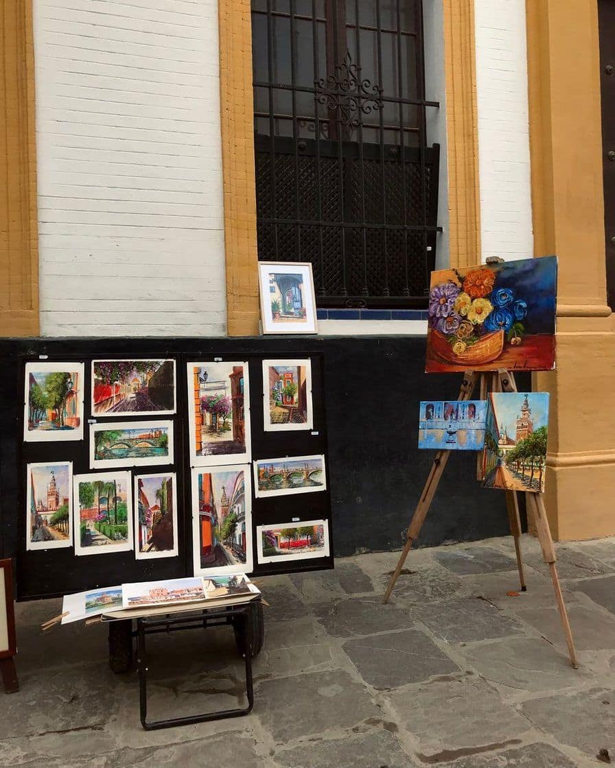 Easel with a canvas being painted in oils in an artist's studio, with brushes and paint on a nearby table